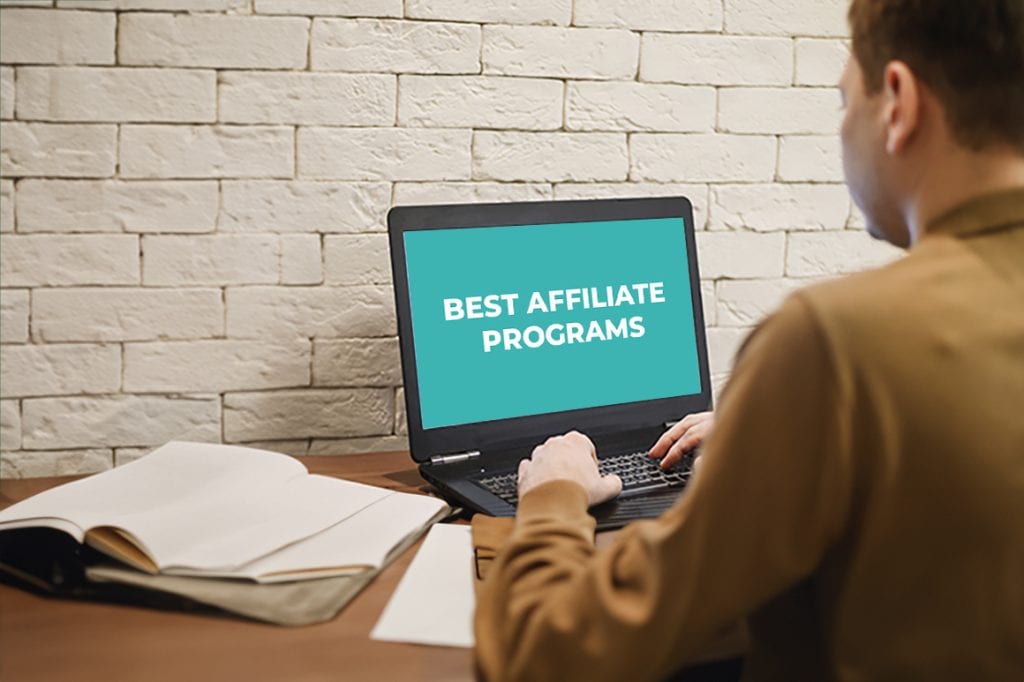 Image of a person looking at a laptop with text "best affiliate programs"