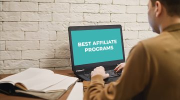 Image of a person looking at a laptop with text "best affiliate programs"